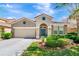 Charming single-story home with a well-manicured lawn, attached garage, and a decorative front entrance at 4416 Acorn Ct, Davenport, FL 33837