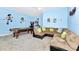 Relax in this vibrant game room with a pool table and comfortable seating for entertainment at 4416 Acorn Ct, Davenport, FL 33837