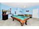 Spacious game room with a pool table and a comfortable seating area; perfect for entertaining guests and Gathering at 4416 Acorn Ct, Davenport, FL 33837