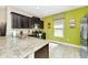 Spacious kitchen with granite countertops, dark wood cabinets, and stainless steel appliances at 4416 Acorn Ct, Davenport, FL 33837