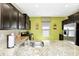 Open kitchen featuring granite countertops, stainless steel appliances, and ample cabinet space at 4416 Acorn Ct, Davenport, FL 33837