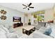 Relaxing living room featuring a large sectional sofa, neutral tones, and sliding doors with access to the pool at 4416 Acorn Ct, Davenport, FL 33837