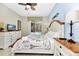 Comfortable main bedroom featuring a ceiling fan, natural light, and a view of the pool area at 4416 Acorn Ct, Davenport, FL 33837
