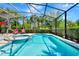 Refreshing screened-in pool with a hot tub, lounge chairs, and lush landscaping, ideal for outdoor enjoyment at 4416 Acorn Ct, Davenport, FL 33837