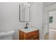 Bathroom featuring wood vanity, modern fixtures, and clean design at 4420 Lake Lawne Ave, Orlando, FL 32808