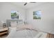 Cozy bedroom with two windows, soft lighting, and stylish bedding at 4420 Lake Lawne Ave, Orlando, FL 32808