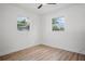 Bright bedroom featuring wood floors and two windows with great natural light at 4420 Lake Lawne Ave, Orlando, FL 32808