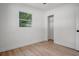 Cozy bedroom featuring wood floors, a closet, and a window with ample natural light at 4420 Lake Lawne Ave, Orlando, FL 32808