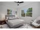 Sunlit bedroom with a large window, neutral tones, and modern decor at 4420 Lake Lawne Ave, Orlando, FL 32808