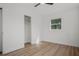 Simple bedroom with wood floors, closet and a window for ample light at 4420 Lake Lawne Ave, Orlando, FL 32808