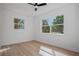 Bright bedroom featuring wood floors, two windows, and ample natural light at 4420 Lake Lawne Ave, Orlando, FL 32808