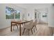 Bright dining room with a view into the front yard through a large window. Features new, light-colored wood flooring at 4420 Lake Lawne Ave, Orlando, FL 32808