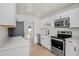This kitchen features sleek white cabinets, modern stainless steel appliances, and plenty of counter space at 4420 Lake Lawne Ave, Orlando, FL 32808