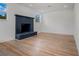 Bright living room area with light wood floors and a modern brick fireplace, complemented by two large windows at 4420 Lake Lawne Ave, Orlando, FL 32808