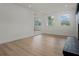 Bright and open living space featuring light hardwood floors, large windows, and a decorative fireplace at 4420 Lake Lawne Ave, Orlando, FL 32808