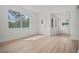 Bright, open-concept living area with light wood floors and a large front-facing window at 4420 Lake Lawne Ave, Orlando, FL 32808