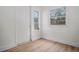 A bright room is freshly painted with laminate wood flooring and trim at 4420 Lake Lawne Ave, Orlando, FL 32808