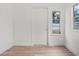 Newly painted room with laminate floors, trim, a window and an exterior door at 4420 Lake Lawne Ave, Orlando, FL 32808