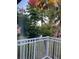 Relaxing balcony view with white railings, featuring tropical foliage, palm trees, and manicured lawn at 492 Banyon Tree Cir # 204, Maitland, FL 32751