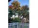 Scenic balcony view showcasing lush tropical landscaping with palm trees and blossoming trees against a serene sky at 492 Banyon Tree Cir # 204, Maitland, FL 32751