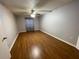 Spacious bedroom featuring wood floors and a ceiling fan with light fixture at 492 Banyon Tree Cir # 204, Maitland, FL 32751