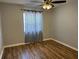 Bedroom with wood flooring, ceiling fan, and natural light at 492 Banyon Tree Cir # 204, Maitland, FL 32751