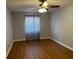 Bedroom featuring wood floors, ceiling fan, and window at 492 Banyon Tree Cir # 204, Maitland, FL 32751