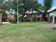 Exterior shot of brick apartment buildings surrounded by a lush green community lawn and mature trees at 492 Banyon Tree Cir # 204, Maitland, FL 32751
