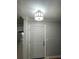 Entryway featuring a modern light fixture above a white front door at 492 Banyon Tree Cir # 204, Maitland, FL 32751