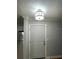 Entryway featuring a modern light fixture above a white front door at 492 Banyon Tree Cir # 204, Maitland, FL 32751
