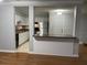 Open kitchen with breakfast bar, white cabinets, stainless steel appliances and tile floors at 492 Banyon Tree Cir # 204, Maitland, FL 32751