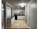 Bright kitchen features white cabinets, modern appliances, and neutral countertops at 492 Banyon Tree Cir # 204, Maitland, FL 32751