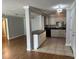 Open kitchen floor plan with tiled floors, island, and black appliances at 492 Banyon Tree Cir # 204, Maitland, FL 32751