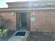 Exterior view of laundry room facility featuring brick facade, clear signage, and convenient access at 492 Banyon Tree Cir # 204, Maitland, FL 32751