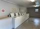 Functional laundry room equipped with multiple washing machines, providing residents with convenient on-site laundry facilities at 492 Banyon Tree Cir # 204, Maitland, FL 32751