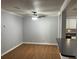 Bright living room featuring wood floors, ceiling fan, and neutral wall colors at 492 Banyon Tree Cir # 204, Maitland, FL 32751