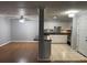 Open living room and kitchen features white cabinets, stainless steel appliances and tile floors at 492 Banyon Tree Cir # 204, Maitland, FL 32751