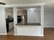 Open living room and kitchen features white cabinets, stainless steel appliances and tile floors at 492 Banyon Tree Cir # 204, Maitland, FL 32751