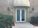 Condo association office entrance with brick pathway, double doors, and decorative lighting at 492 Banyon Tree Cir # 204, Maitland, FL 32751