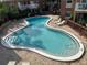 Beautifully designed community pool with brick pool deck and comfortable lounge chairs at 492 Banyon Tree Cir # 204, Maitland, FL 32751