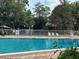 Inviting community pool area surrounded by lush trees and foliage at 492 Banyon Tree Cir # 204, Maitland, FL 32751