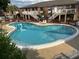 Scenic community pool features stair entrances, and plenty of sunbathing area for residents at 492 Banyon Tree Cir # 204, Maitland, FL 32751