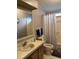 Standard bathroom with a single sink vanity and a shower/tub with patterned curtain at 503 Tivoli Park Dr, Davenport, FL 33897