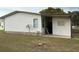 Rear exterior showcasing siding, a covered carport, and a well-maintained lawn surrounding the property at 503 Tivoli Park Dr, Davenport, FL 33897