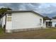 Exterior side view of the house with a covered parking area showcasing the home's design at 503 Tivoli Park Dr, Davenport, FL 33897