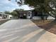 Exterior shot of a home with a long driveway and covered parking offering shade and convenience at 503 Tivoli Park Dr, Davenport, FL 33897
