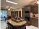Open kitchen with cooktop island and adjacent dining area with screened patio access at 503 Tivoli Park Dr, Davenport, FL 33897