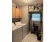 Functional laundry room equipped with a washer, dryer, and ample storage space at 503 Tivoli Park Dr, Davenport, FL 33897