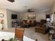Spacious living room with cozy furniture, a ceiling fan, and a large wall-mounted TV at 503 Tivoli Park Dr, Davenport, FL 33897
