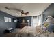 The main bedroom is spacious with a bed, dresser, TV, ceiling fan, and good natural light from the window at 503 Tivoli Park Dr, Davenport, FL 33897